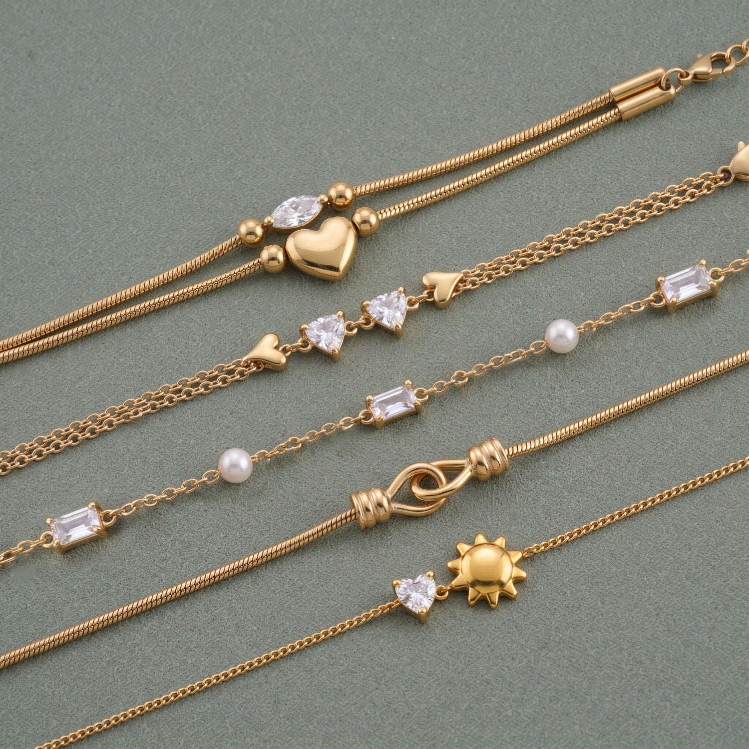 Gold Layered Dainty Bracelet – Heart, Sun, Knot & Pearl Zirconia